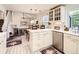 Open kitchen layout with white cabinets, stainless steel appliances, and a breakfast nook at 6379 S Jasmine Way, Centennial, CO 80111