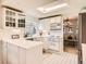 Bright kitchen with garden window, white cabinets, skylight, and modern appliances at 6379 S Jasmine Way, Centennial, CO 80111