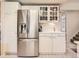 Kitchen featuring stainless steel refrigerator, white cabinetry, and ample counter space at 6379 S Jasmine Way, Centennial, CO 80111