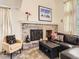 Inviting living room with a brick fireplace, comfortable seating, and a stylish coffee table at 6379 S Jasmine Way, Centennial, CO 80111