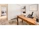 Well-lit office with a wooden desk, a bookshelf, and a view of the doorway at 6379 S Jasmine Way, Centennial, CO 80111