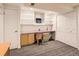 Finished basement home office with built-in shelves, a desk, and two closets at 6379 S Jasmine Way, Centennial, CO 80111