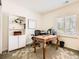 Bright office space featuring a wooden desk, a bookshelf, and a large window at 6379 S Jasmine Way, Centennial, CO 80111