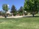 Community park featuring basketball courts, benches, and mature trees at 6379 S Jasmine Way, Centennial, CO 80111