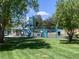 Inviting community playground with slides, swings, and climbing equipment amid lush green lawns and mature shade trees at 6379 S Jasmine Way, Centennial, CO 80111