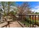 Cozy outdoor balcony with a wooden railing, patio chairs, brick flooring, and views of the yard and neighborhood at 368 S Humboldt St, Denver, CO 80209