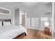 Bedroom features hardwood floors, large windows, three closets, and decorative furnishings at 368 S Humboldt St, Denver, CO 80209