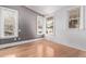 Bedroom with three large windows providing ample natural light to the hardwood flooring at 368 S Humboldt St, Denver, CO 80209