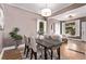 Open dining room featuring a wooden table with upholstered chairs, and large windows for natural light at 368 S Humboldt St, Denver, CO 80209