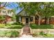 Beautiful exterior view of a home with a well-maintained lawn, a porch, and lovely landscaping at 368 S Humboldt St, Denver, CO 80209