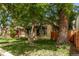Picture of the front of a house showing mature trees and a quaint covered porch at 368 S Humboldt St, Denver, CO 80209