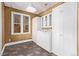 Functional laundry room with ample storage, white cabinets, and a window for natural light at 368 S Humboldt St, Denver, CO 80209