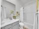 Bathroom with a tiled shower and bathtub combo, gray vanity, and marble countertop at 2059 S Vance Way, Denver, CO 80227