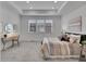 Bright and airy main bedroom features plush carpeting, lots of natural light, and tray ceilings at 2059 S Vance Way, Denver, CO 80227