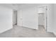 Bright bedroom featuring neutral carpeting, white walls, and two closets at 2059 S Vance Way, Denver, CO 80227