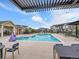 Community pool with comfortable lounge chairs and seating areas at 2059 S Vance Way, Denver, CO 80227