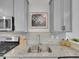 Close up on the kitchen sink features stainless appliances and grey stone countertops at 2059 S Vance Way, Denver, CO 80227