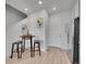 Light and airy kitchen features a round dining table with seating for two and modern fixtures at 2059 S Vance Way, Denver, CO 80227