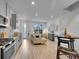 Open concept living and kitchen area features light hardwood floors, lots of light and modern decor at 2059 S Vance Way, Denver, CO 80227