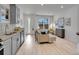 Open-concept living room with a modern aesthetic, kitchen and comfortable seating at 2059 S Vance Way, Denver, CO 80227