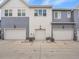 Exterior shot of townhomes featuring attached garages and contemporary designs at 2059 S Vance Way, Denver, CO 80227