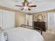 Neutral bedroom with a ceiling fan, dresser, and ensuite bathroom at 13762 W 67Th Pl, Arvada, CO 80004