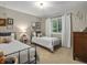 Charming bedroom with twin beds, natural light, and neutral decor at 13762 W 67Th Pl, Arvada, CO 80004
