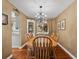 Traditional dining room featuring a chandelier, wood table with seating for six, and a china cabinet at 13762 W 67Th Pl, Arvada, CO 80004