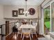 Elegant dining room features hardwood floors, decorative lighting, and a view of the living room fireplace at 13762 W 67Th Pl, Arvada, CO 80004