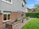 Raised garden beds along the side of the house with brick accents at 13762 W 67Th Pl, Arvada, CO 80004