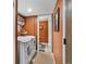 Functional laundry room featuring a washer and dryer, storage shelves, and bright lighting at 13762 W 67Th Pl, Arvada, CO 80004