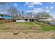 Spacious backyard with a well-maintained lawn, mature trees, and a wooden fence, perfect for outdoor activities at 6913 Teller Ct, Arvada, CO 80003
