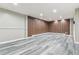 Finished basement with wood accent wall and hardwood floors at 6913 Teller Ct, Arvada, CO 80003