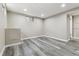 Finished basement featuring neutral colored walls and hardwood floors at 6913 Teller Ct, Arvada, CO 80003