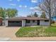 Charming single-story home with a well-maintained lawn, attached garage, and classic brick detailing at 6913 Teller Ct, Arvada, CO 80003