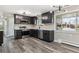 A well-lit kitchen features stainless steel appliances, granite countertops and hardwood floors at 6913 Teller Ct, Arvada, CO 80003