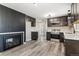 A well-lit kitchen features stainless steel appliances, granite countertops and hardwood floors at 6913 Teller Ct, Arvada, CO 80003