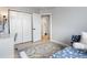 Bright bedroom featuring hard wood floors, closet, and view into bathroom at 23222 E Orchard Pl, Aurora, CO 80015
