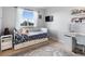 Cozy bedroom with hardwood floors, built-in bed, and lots of natural light from a large window at 23222 E Orchard Pl, Aurora, CO 80015