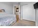 Comfortable bedroom with hard wood floors, closet, and view into hallway and kitchen at 23222 E Orchard Pl, Aurora, CO 80015