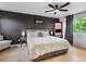 Comfortable bedroom featuring a large bed, accent wall, and natural light at 23222 E Orchard Pl, Aurora, CO 80015