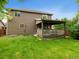 The backyard includes a lovely deck and lush green grass, perfect for entertainment at 23222 E Orchard Pl, Aurora, CO 80015