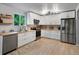 Bright kitchen featuring white cabinets, light countertops, stainless steel appliances, and plank flooring at 23222 E Orchard Pl, Aurora, CO 80015