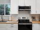 Close-up of the kitchen featuring light countertops, stainless steel appliances, and white cabinets at 23222 E Orchard Pl, Aurora, CO 80015