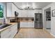 Bright kitchen featuring stainless steel appliances, white cabinets, and light countertops and flooring at 23222 E Orchard Pl, Aurora, CO 80015