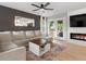 Stylish living room featuring fireplace, french doors, cozy sectional, and wood-look flooring at 23222 E Orchard Pl, Aurora, CO 80015