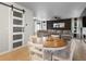 Open floor plan with dining area, sliding barn door, and comfortable seating at 23222 E Orchard Pl, Aurora, CO 80015