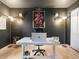 Chic home office with dark accent wall, modern desk, and stylish lighting at 23222 E Orchard Pl, Aurora, CO 80015