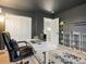 Inviting home office with dark wall, modern desk, and shelving at 23222 E Orchard Pl, Aurora, CO 80015