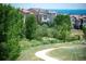 Backyard view of lush greenery and community landscaping in a quiet neighborhood at 2592 S Norse Ct, Lakewood, CO 80228